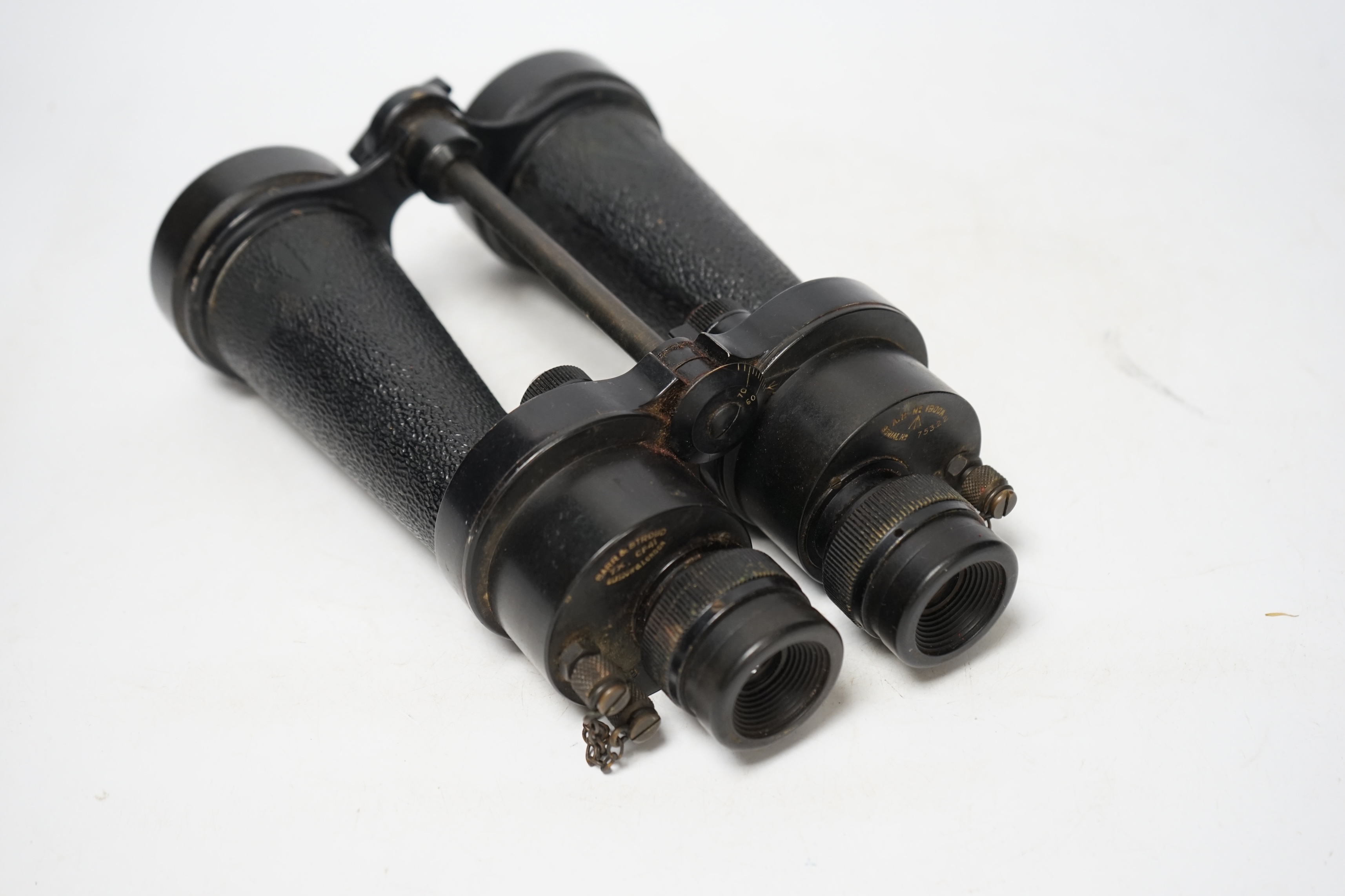 A pair of brown leather cased WWII Naval binoculars, Barr & Stroud, binoculars 24cm long, Condition - leather shoulder strap missing, front strap worn from use, binoculars appear good/used